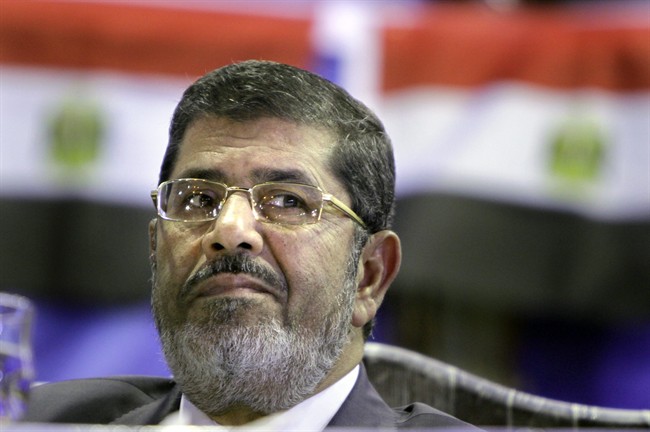 In this Monday, April 30, 2012 file photo, Mohammed Morsi, Muslim Brotherhood's presidential candidate, listens during a campaigning conference in Cairo Egypt.
