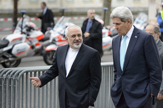 FILE - In this file photo taken Wednesday, Jan. 14, 2015, U.S. Secretary of State John Kerry, right, speaks with Iranian Foreign Minister Mohammad Javad Zarif, as they walk in Geneva, Switzerland, ahead of the next round of nuclear discussions. 