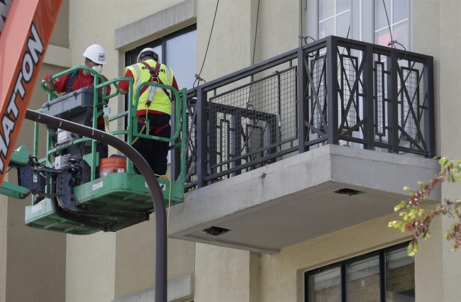 A crew begins work on the Library Gardens apartment building balcony below the remaining wood from a balcony that collapsed in Berkeley, Calif., Wednesday, June 17, 2015. The balcony broke loose from the building during a 21st birthday party early Tuesday, killing several people and seriously injuring others. 