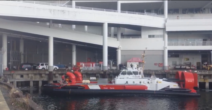 Coast Guard assist Vancouver Police and Transit Police in extracting a man who jumped into the ocean and under Canada Place to escape police after robbing a Tim Hortons on June 27, 2015.