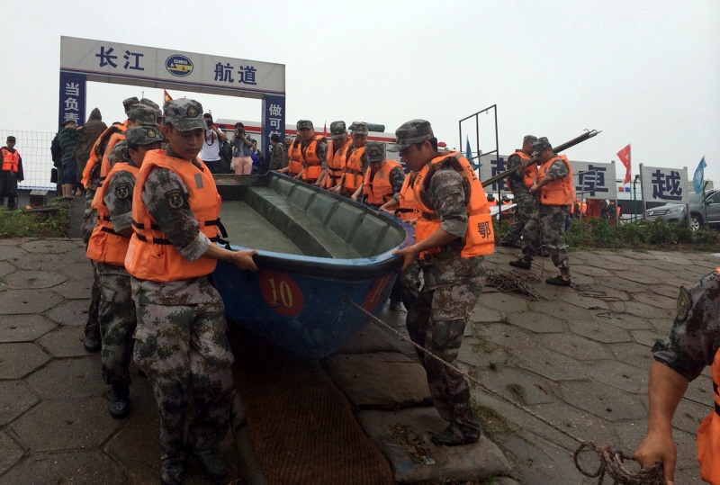 Rescue workers prepare to head out on boats on the Yangtze River to search for missing passengers after a ship capsized in central China’s Hubei province Tuesday, June 2, 2015.