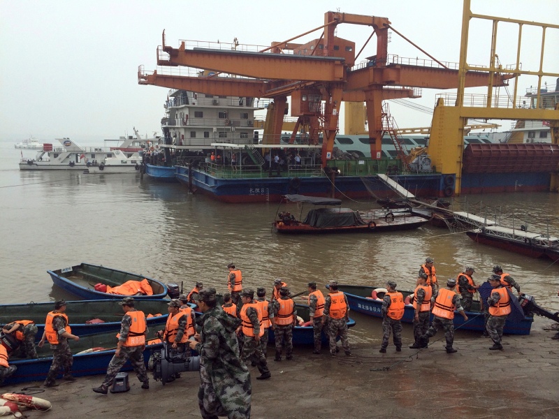 Rescue workers prepare to head out on boats on the Yangtze River to search for missing passengers after a ship capsized in central China’s Hubei province Tuesday, June 2, 2015.