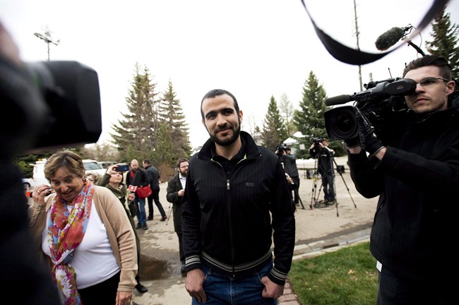 Omar Khadr walks back to his home after speaking to the media after being granted bail in Edmonton on May 7, 2015.