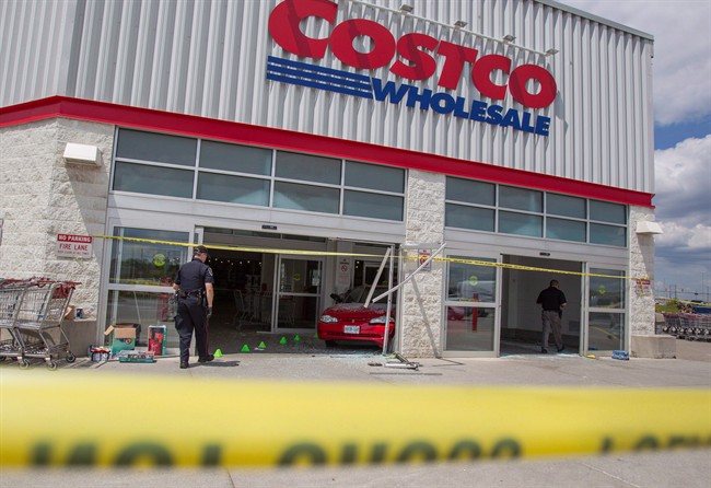 FILE - Police investigate after a car backed through the entrance of Costco in London, Ont., on July 25, 2014. A 66-year-old woman accused in the deaths of a young girl and a newborn after her car smashed into a Costco store in London, Ont., last summer has been found guilty of dangerous driving. Ruth Burger had pleaded not guilty to two counts of criminal negligence causing death and two counts of criminal negligence causing bodily harm in the case.