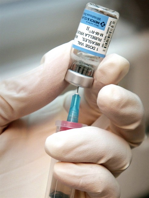 A nurse draws a dose of mumps, measles, and rubella vaccine in Wichita, Kan., April 24, 2006.