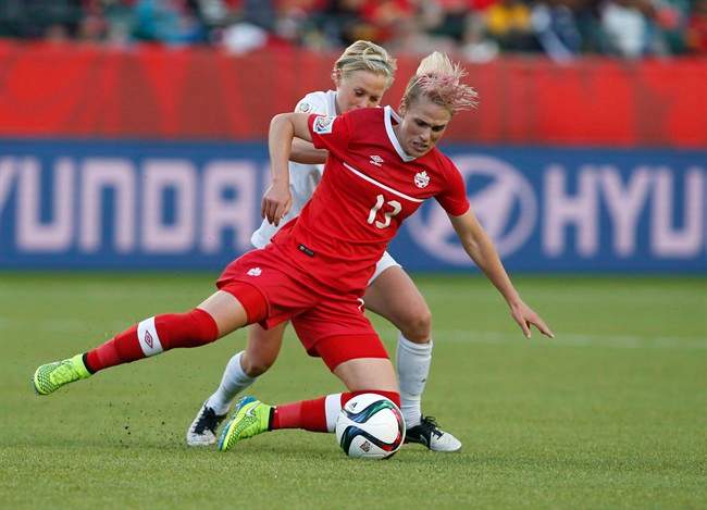 Canada’s Sophie Schmidt and New Zealand’s Betsy Hassett battle for the ball during second half FIFA Women’s World Cup soccer action in Edmonton, Alta., Thursday, June11, 2015.