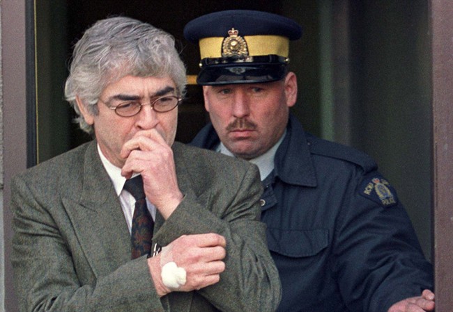 Larry Fisher is led out of the Yorkton, Sask., courthouse, on Saturday, Nov. 20, 1999.