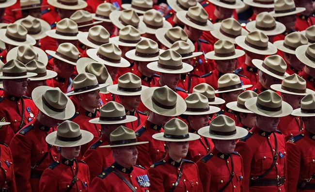 A moment of silence is observed at the regimental funeral for three RCMP officers who were killed on duty, at the Moncton Coliseum in Moncton, N.B. on Tuesday, June 10, 2014.