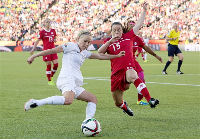 Canada's Allysha Chapman (15) and New Zealand's Kirsty Yallop (11) battle for the ball during FIFA World Cup.