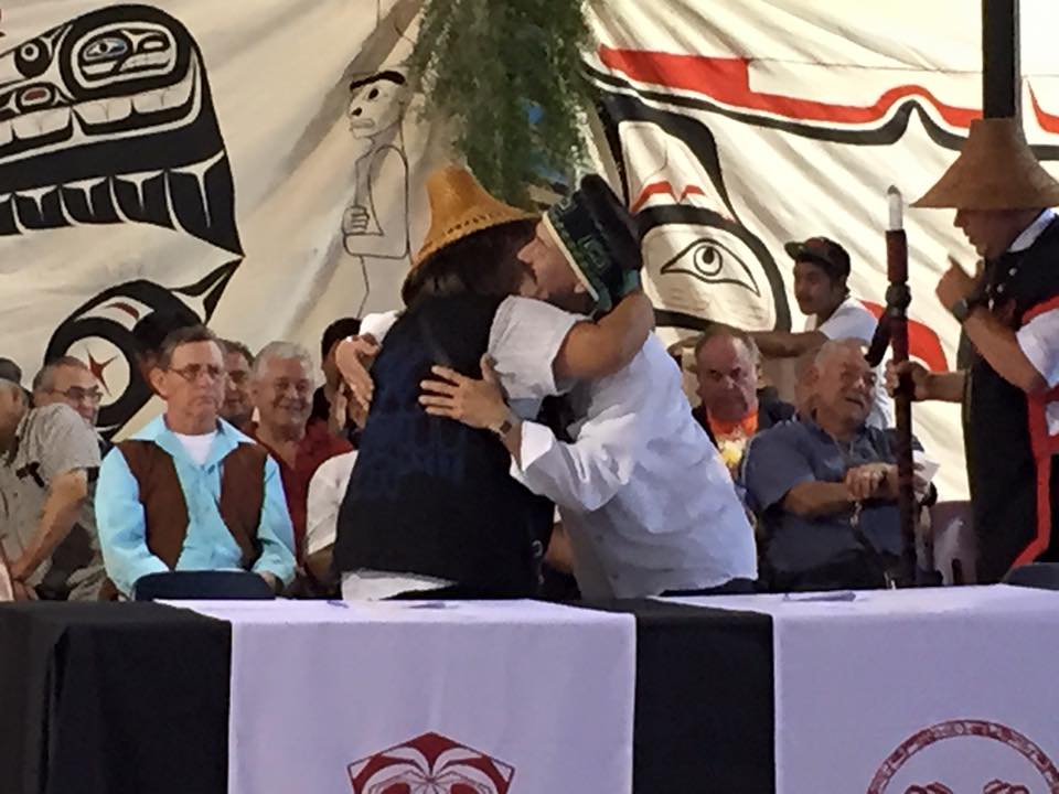 Lorena White, Heiltsuk Tribal Council member, and Harold Yeltatzie, Old Massett Village Council member, embrace after signing the peace treaty