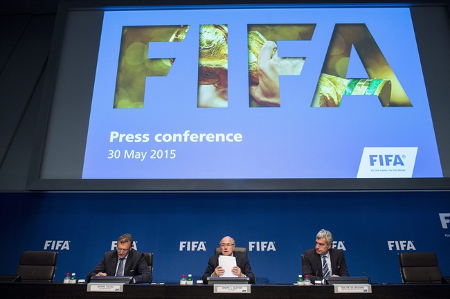 FILE - In this May 30, 2015 file photo FIFA President Sepp Blatter, center, speaks next to Jerome Valcke, FIFA Secretary General, left, and Walter De Gregorio, Director Communications and Public Affairs, right, during a news conference following the FIFA Executive Committee meeting in Zurich, Switzerland. (Ennio Leanza/Keystone via AP, file).