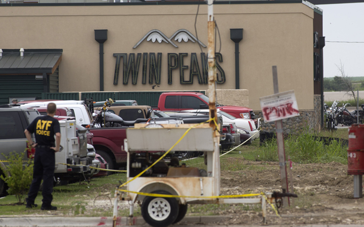 Law enforcement officers investigating the scene and providing security near Twin Peaks restaurant on Monday, May 18, 2015 in Waco, Texas.