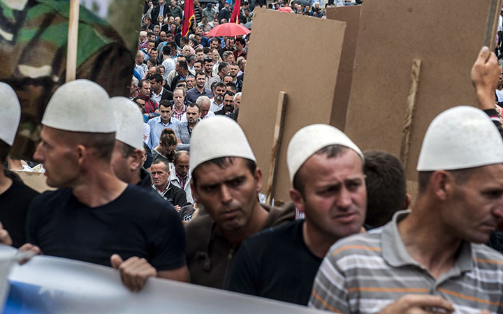 Kosovo Albanians wearing traditional hats take part in a protest in Pristina on June 17, 2015, against the creation of a new EU-backed court that will try former Kosovo guerrilla fighters suspected of war crimes allegedly committed during and after the 1998-99 conflict.