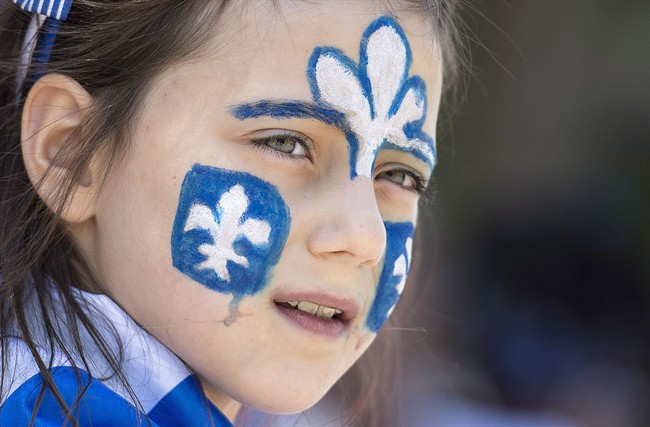 A young girl watches the annual St-Jean-Baptiste Day parade in this file photo.