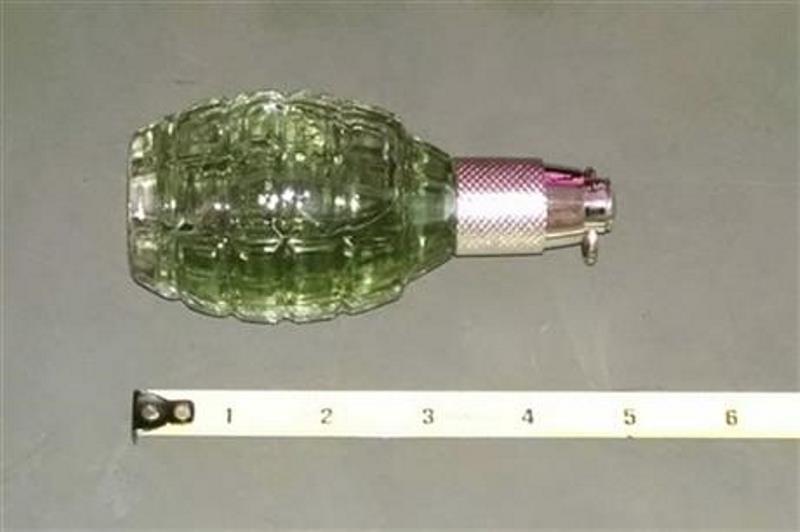 This photo provided by the Hamilton County Sheriff's Office shows a perfume bottle that caused an evacuation of the Hamilton County courthouse in downtown Cincinnati on Tuesday, June 30, 2015. The suspicious item that prompted a Cincinnati courthouse evacuation turned out to be a perfume bottle shaped like a World War II grenade. 