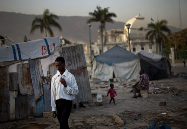 A man walks between the remaining tents and makeshift shelters in front of the collapsed National Palace in Port-au-Prince, Haiti, Wednesday March 14, 2012. (File photo).