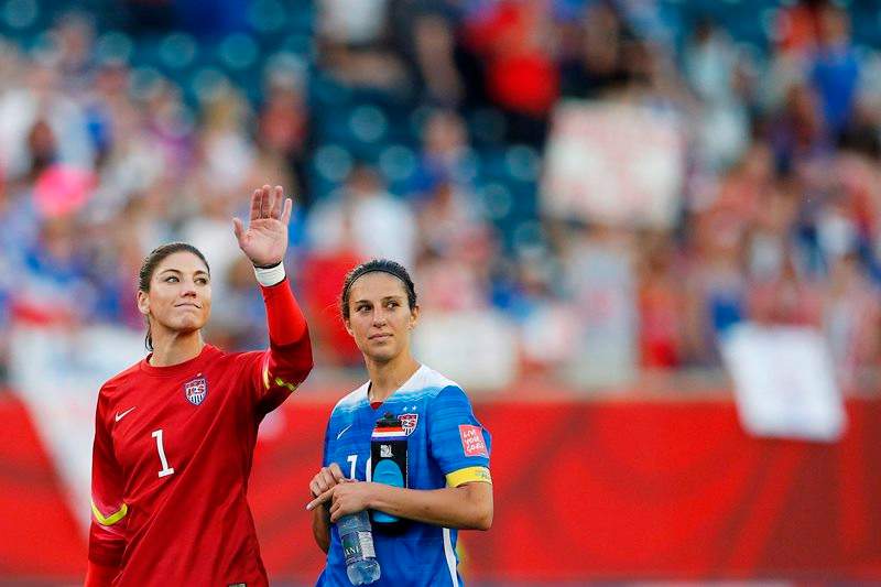 United States goalkeeper Hope Solo (1) waves to the crowd with teammate Carli Lloyd (10) after their draw against Sweden in FIFA Women's World Cup soccer action in Winnipeg on Friday, June 12, 2015. 