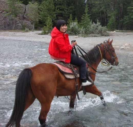 Jessica Lai having the time of her life horseback riding in Banff.