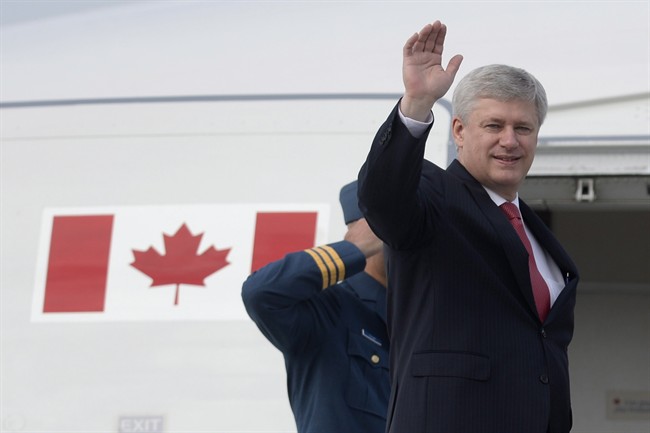 Canadian Prime Minister Stephen Harper waves as he boards a plane in Ottawa on Friday, June 5, 2015. Harper is travelling until June 11 visiting Ukraine, Germany for the G7 meeting, Poland and Italy. 