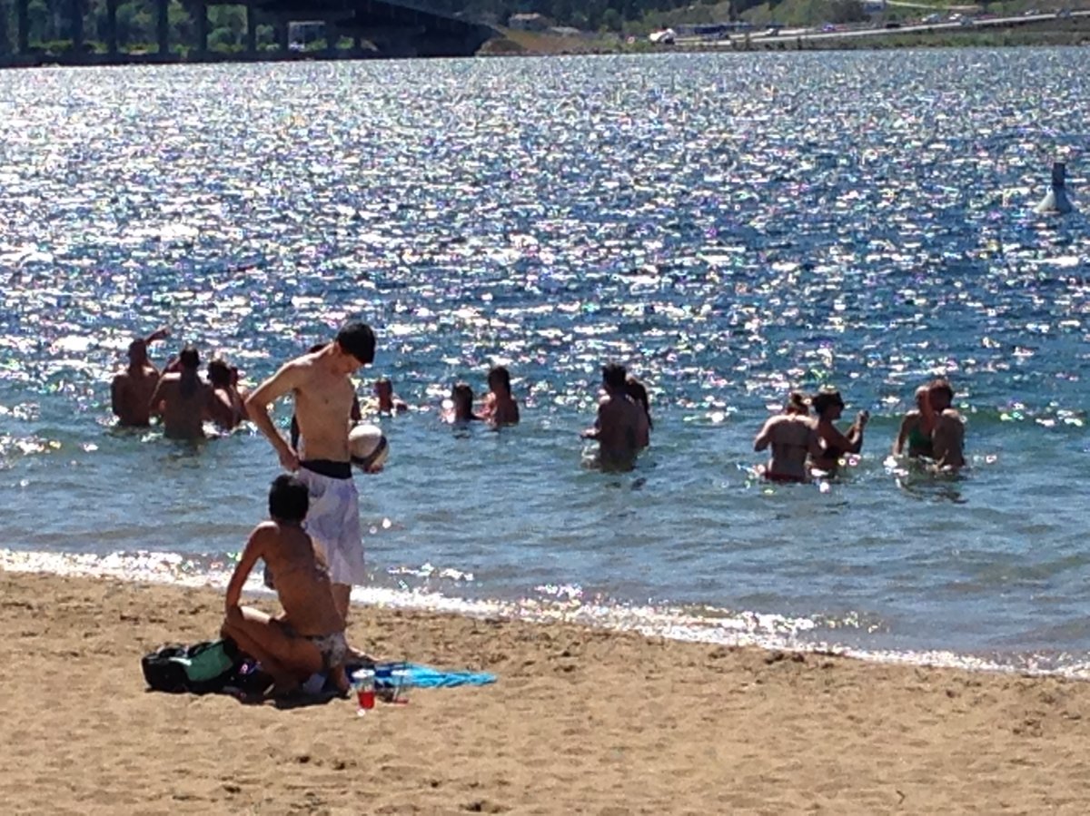 People enjoying the beautiful weather at City Park in Kelowna on the record-breaking hot Monday afternoon. 