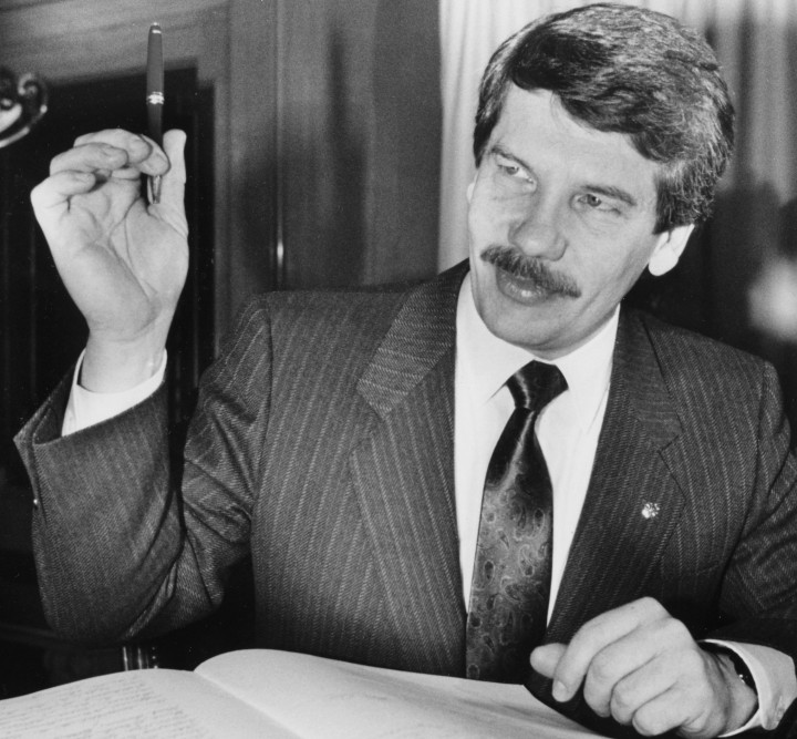 Montreal Mayor Jean Doré raises a pen before signing the City Register after being sworn in, Montreal, Que., Nov. 20, 1986.