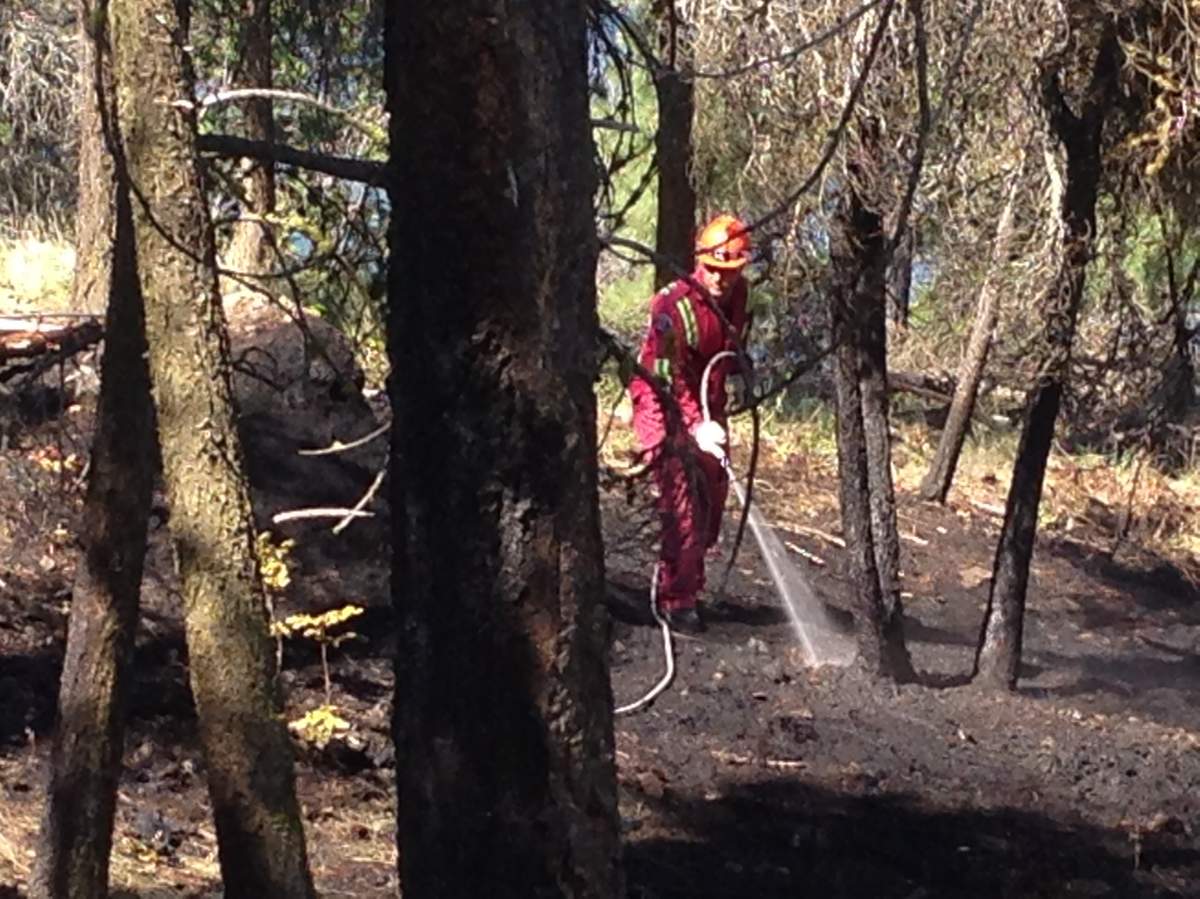 Crews continue working Monday morning after fire in Knox Mountain Park Sunday night.