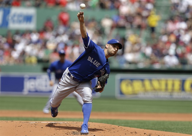 Toronto Blue Jays' Marco Estrada delivers a pitch against the Boston Red Sox in the first inning of a baseball game at Fenway Park, Sunday, June 14, 2015, in Boston.