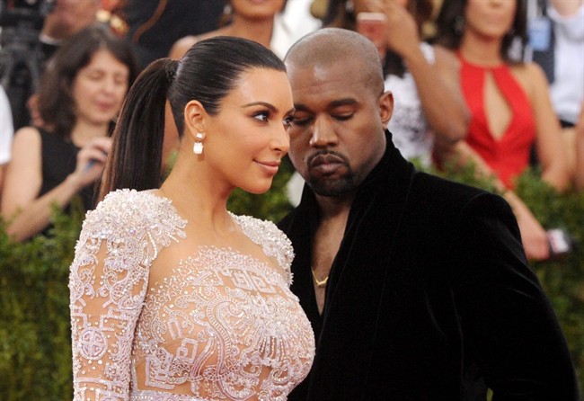 File-This May 4, 2015, file photo shows Kim Kardashian, left, and Kanye West arriving at The Metropolitan Museum of Art's Costume Institute benefit gala in New York. Kardashian says she is pregnant with her second child with West.