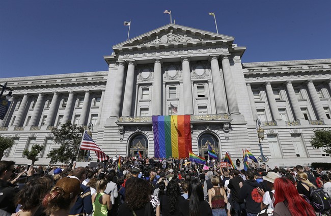 FILE - In this June 26, 2015, file photo, a crowd gathers as San Francisco Mayor Ed Lee speaks at a news conference outside of City Hall in San Francisco, after the U.S. Supreme Court ruled that same-sex couples have the right to marry nationwide.