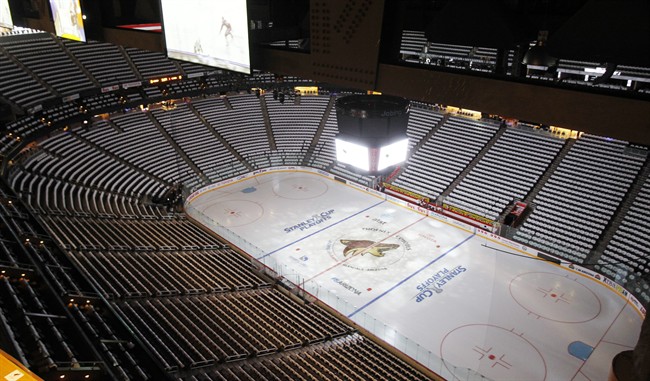 FILE - In this April 12, 2011, file photo, the Jobing.com Arena, home of the NHL hockey Phoenix Coyotes, sits empty before a Stanley Cup playoff game in Glendale, Ariz.