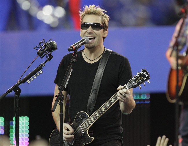 FILE - In this Nov. 24, 2011 file photo, Nickelback lead vocalist Chad Kroeger and his band perform during halftime of an NFL football game between the Detroit Lions and the Green Bay Packers in Detroit. 