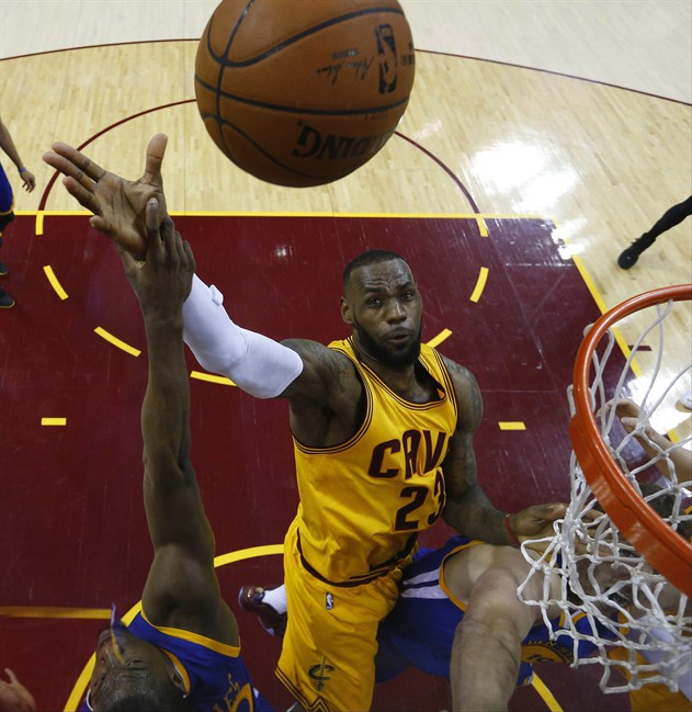Cleveland Cavaliers forward LeBron James (23) shoots over Golden State Warriors forward Harrison Barnes (40) during the second half of Game 4 of basketball's NBA Finals in Cleveland, Thursday, June 11, 2015. 