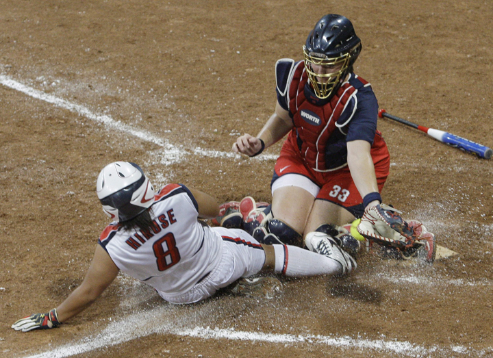 FILE - This is a  Thursday, Aug. 21, 2008. file photo of Japan's Megu Hirose scores as USA catcher Stacey Nuveman tries to apply the tag in the seventh inning in the gold medal softball game in the Beijing 2008 Olympics in Beijing. Japan won 3-1. The sports of Softball and Baseball are hoping to be included into the 2020 Olympic Games. (AP Photo/Elaine Thompson, File).