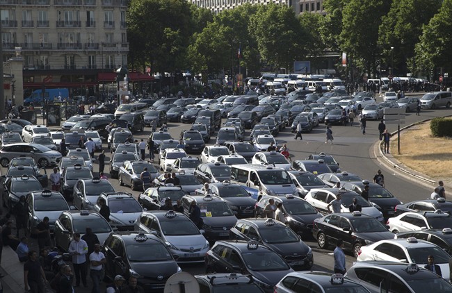 Taxis gather at a major entrance of Paris, Thursday, June 25, 2015 in Paris. 