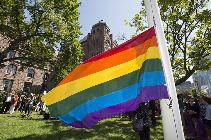 The Pride flag hangs from the flagpole in front of the Ontario legislature at Queen's Park in Toronto on Monday, June 22, 2015. 