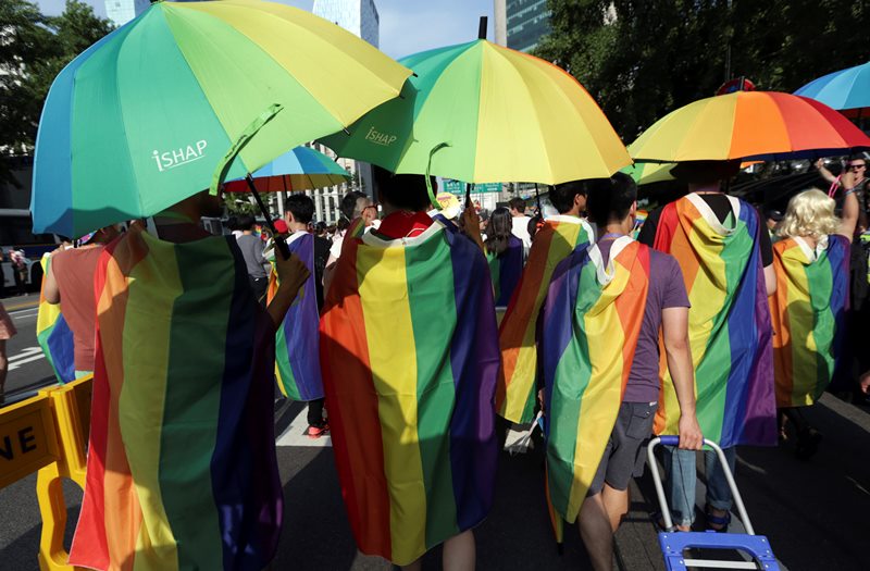 Participants march with rainbow flags and umbrellas during the Korea Queer Festival inSeoul, South Korea, Sunday, June 28, 2015.