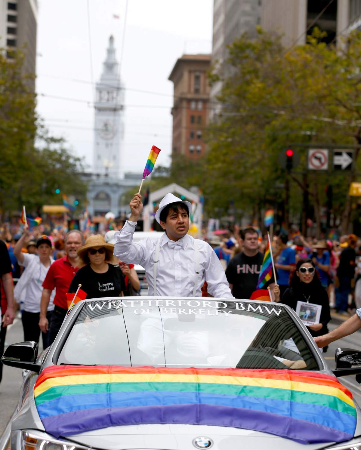 Belo Cipriani, Grand Marshall for the 45th annual Gay Pride parade, waves to the crowd while being driven past them in San Francisco, Sunday, June 28, 2015.