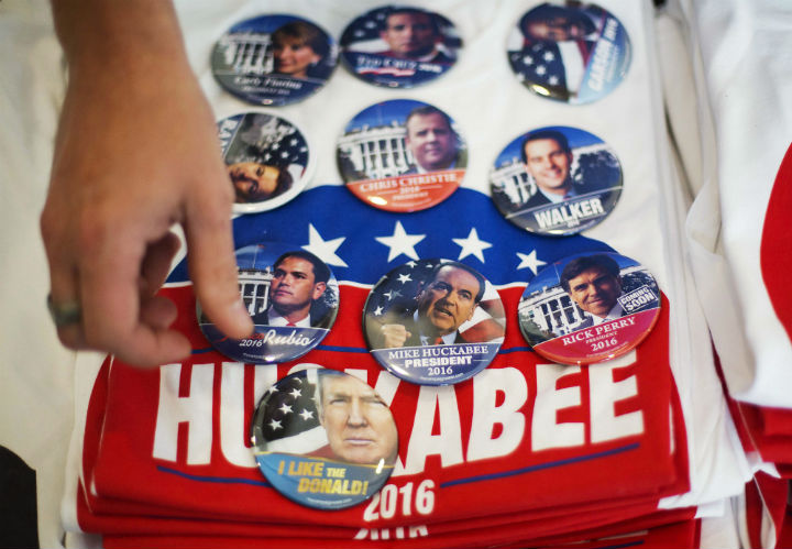 Jon Youngblood lays out campaign buttons for a customer at his booth of merchandise at the Georgia Republican Convention Friday, May 15, 2015, in Athens, Ga.