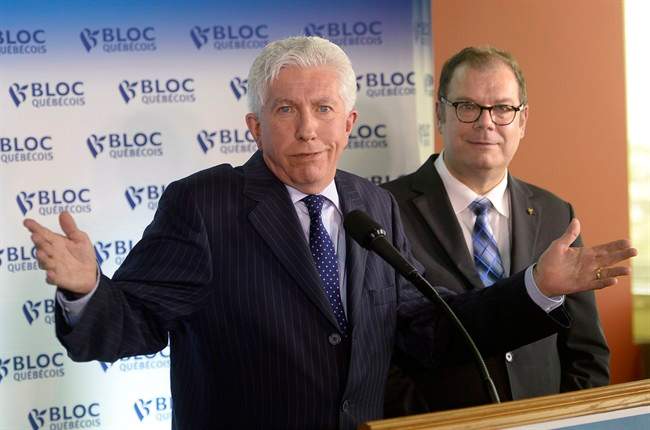 Bloc Quebecois Leader Gilles Duceppe gestures at a news conference in Montreal on Wednesday, June 10, 2015 as party president Mario Beaulieu looks on. 