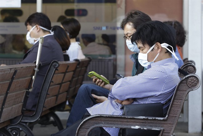 South Koreans wearing masks as a precaution against the Middle East Respiratory Syndrome virus sit at an emergency room at Seoul National University Hospital in Seoul, South Korea Monday, June 1, 2015. More than 680 people in South Korea are isolated after having contact with patients infected with a virus that has killed hundreds of people in the Middle East, health officials said Monday. (AP Photo/Ahn Young-joon).