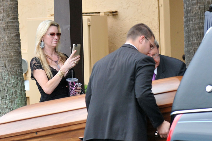 Jackie Siegel, pictured taking photos or video of her daughter's casket on June 9, 2015.