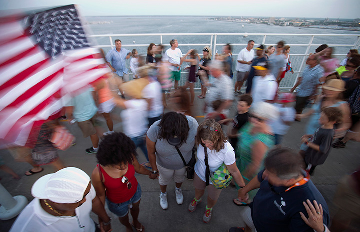 People join hands in prayer as thousands of marchers meet on Charleston's main bridge in a show of unity after nine black church parishioners were gunned down during a Bible study, Sunday, June 21, 2015, in Charleston, S.C. 