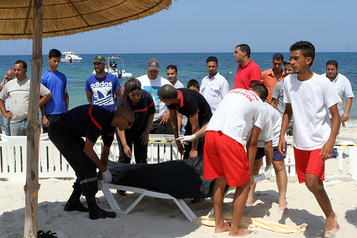 Tunisian lifeguards and medics transport a body in the resort town of Sousse, a popular tourist destination 140 kilometres south of the Tunisian capital, on June 26, 2015. 