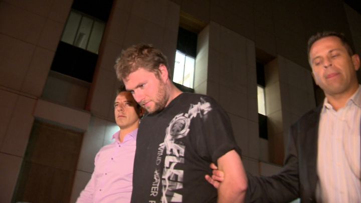 Spencer Jordan being led to arrest processing in Calgary in 2012, charged with killing his daughter Meika Jordan.