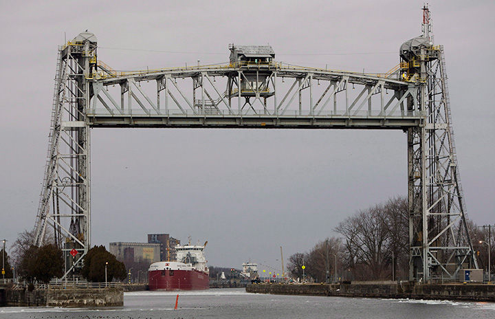 Ice floats past ships in the Welland Canal near Lock 8 in Port Colborne, Ont., Friday, March 28, 2014. 