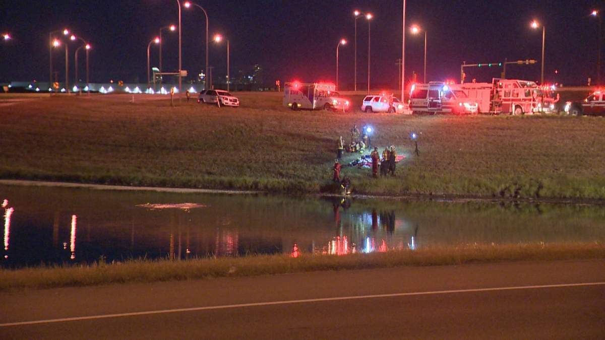Vehicle submerged in a retaining pond at the intersection of Stoney Trail and Glenmore Trail.