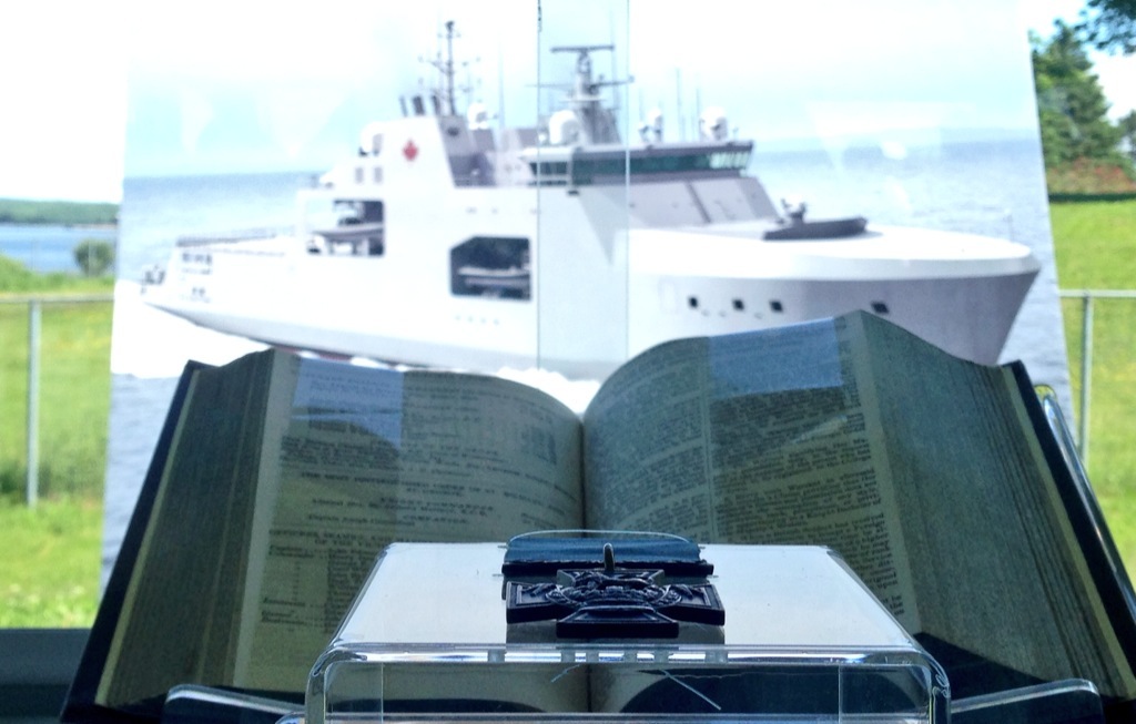 The Victoria Cross presented to William Hall sits in front of a drawing for the Arctic Offshore Patrol Ship that will one day bear his name.