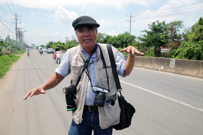Pulitzer winning photographer Nick Ut gestures while talking with media at the place where he took his iconic 'Napalm girl' photo 43 years ago on Monday, June 8, 2015 in Trang Bang, Vietnam. 