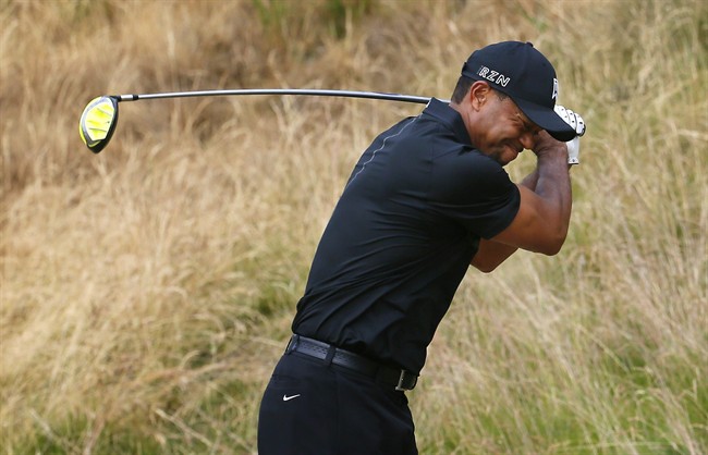 Tiger Woods reacts to his tee shot on the eighth hole during the first round of the U.S. Open golf tournament at Chambers Bay on Thursday, June 18, 2015 in University Place, Wash. (AP Photo/Matt York).