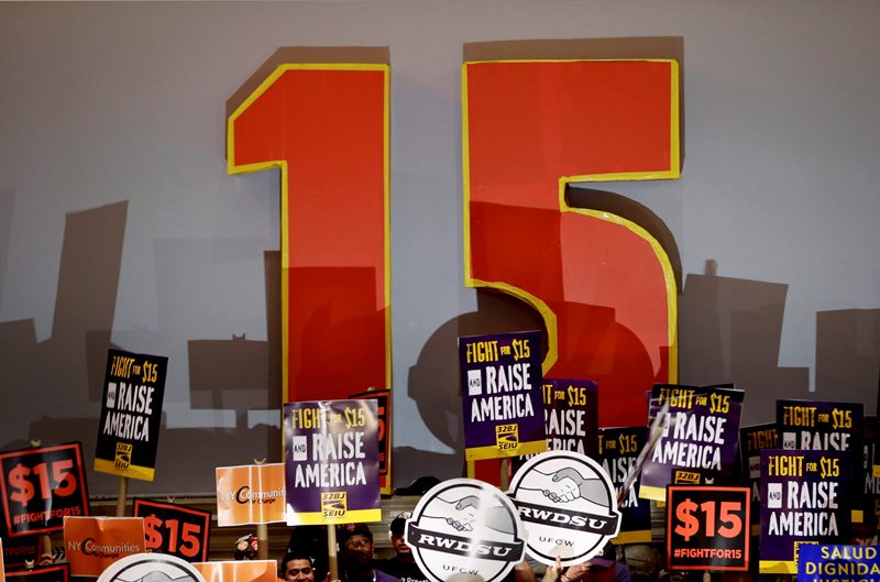 Demonstrators rally for a $15 minimum wage before a meeting of the wage board in New York, Monday, June 15, 2015.  A new study has found CEO pay is rapidly increasing,, while worker pay has stagnated since 2009.
